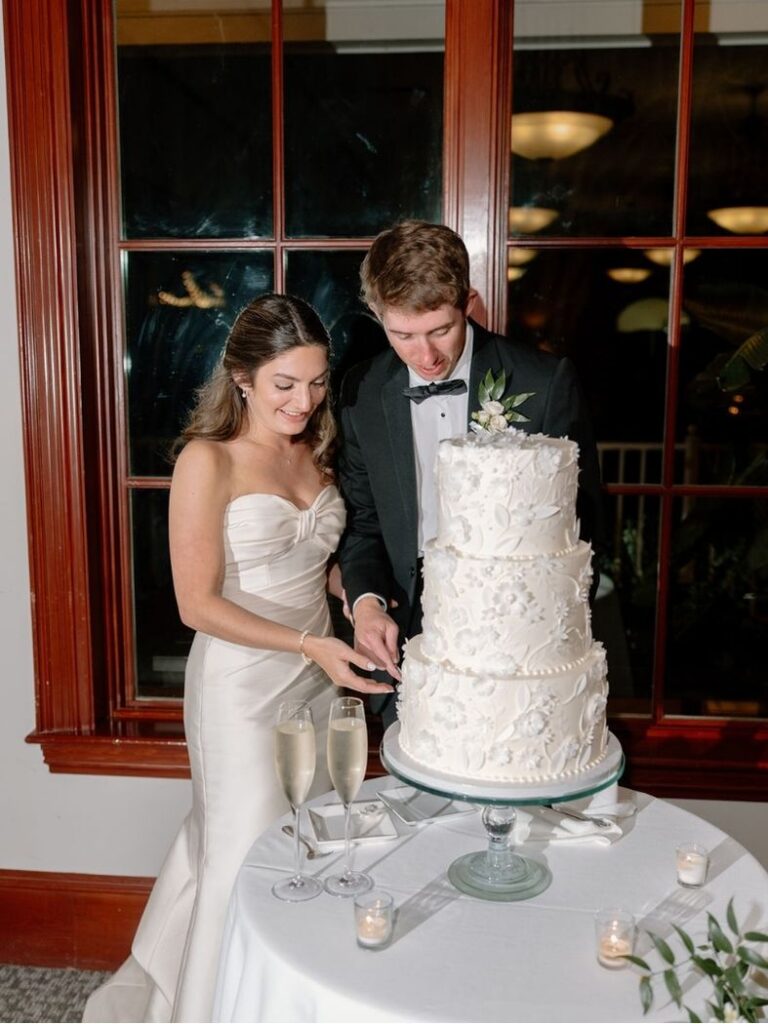 Luxury couple cutting wedding cake at Port Rpyal plantation in Hilton Head Island SC